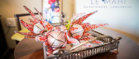 A decorative tray with a lobster centerpiece on a wooden table.