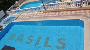 A swimming pool with the word "BASILIS" tiled on the floor. - Basil's Apart Hotel (Marmaris)
