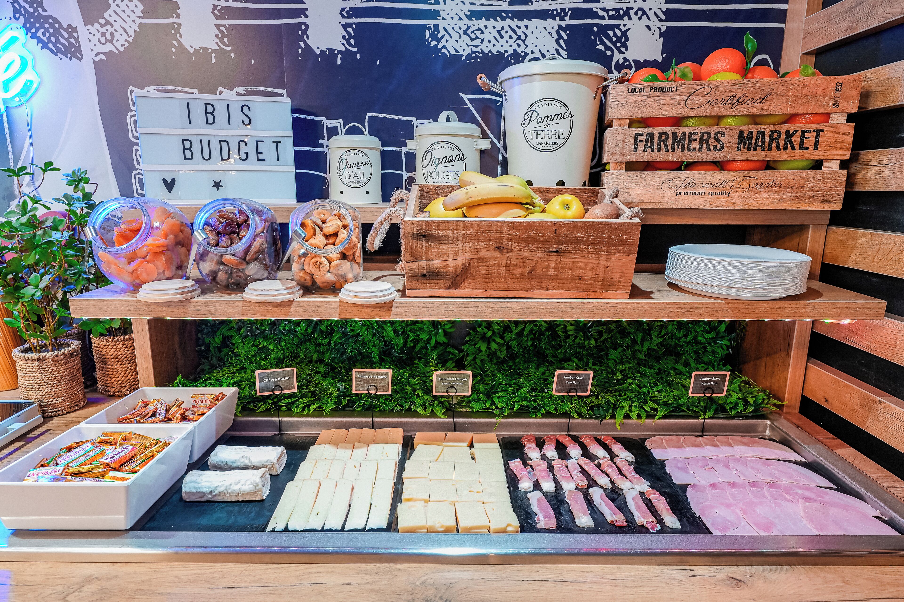 A food display with various items including fruits, cheeses, and meats.