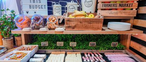 A food display with various items including fruits, cheeses, and meats.