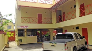A hotel with a reception area and a parking lot.
