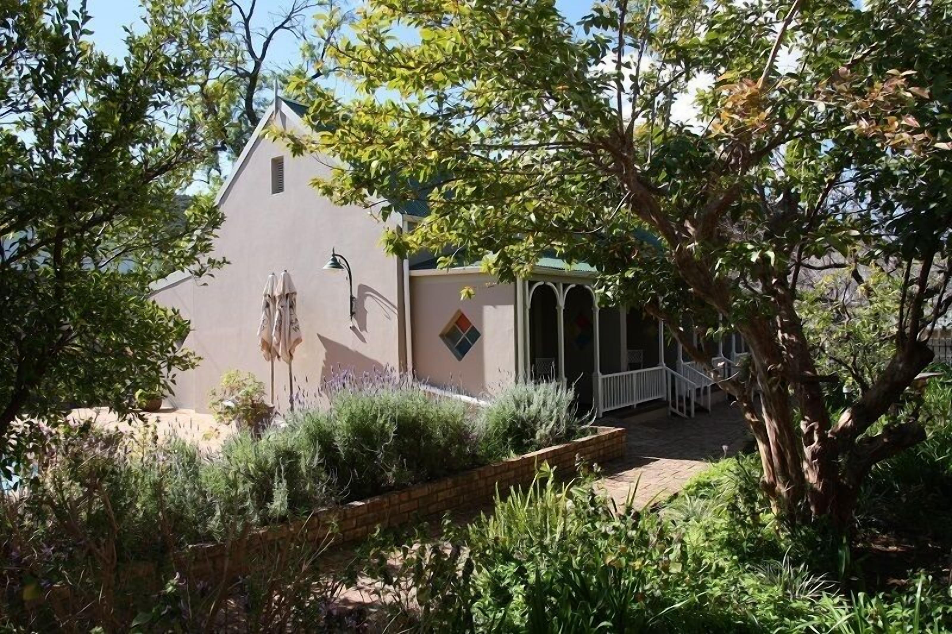 A building with a sloped roof and a small porch area.