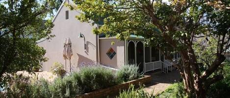 A building with a sloped roof and a small porch area.