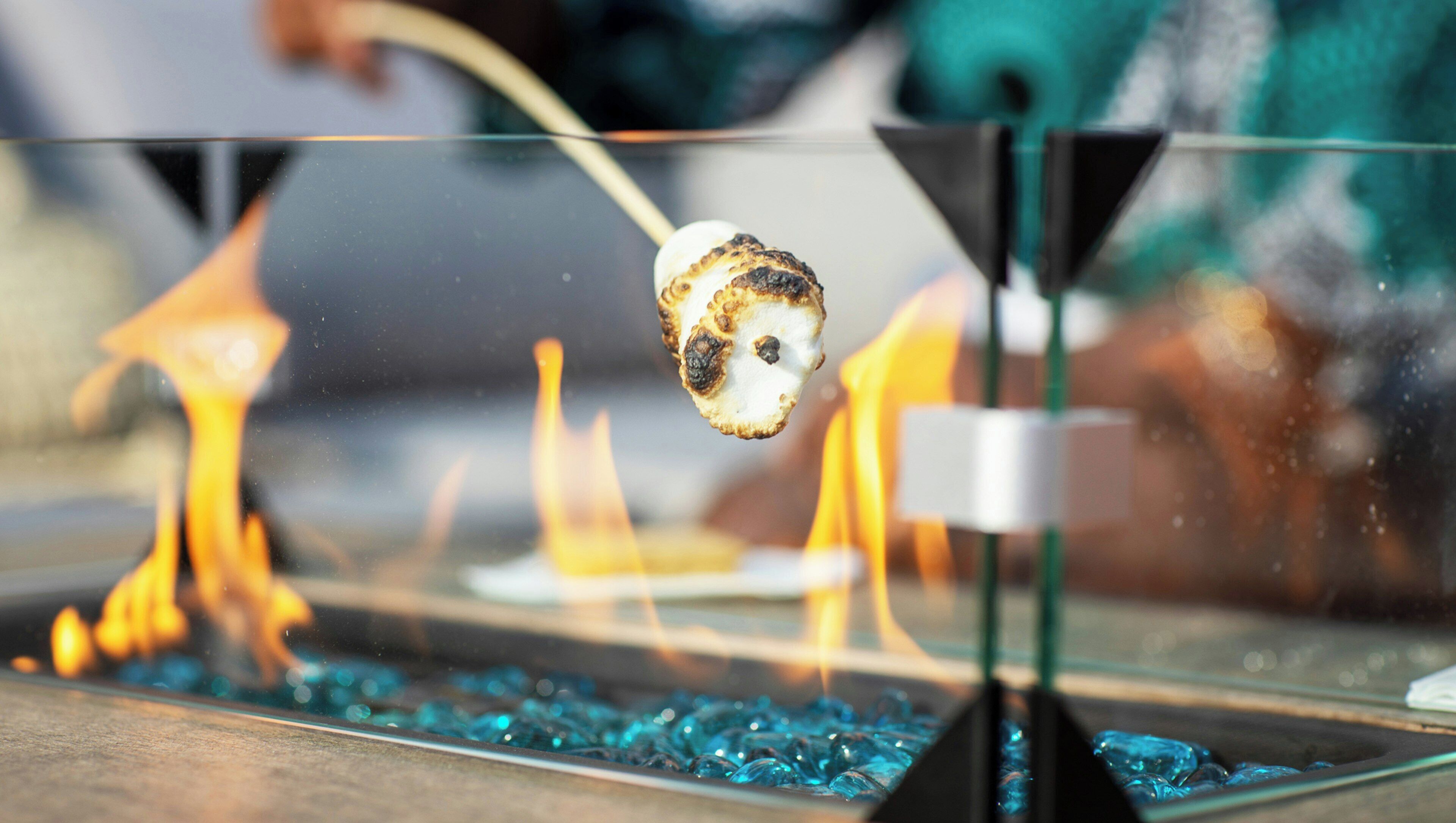 A close-up of a marshmallow being roasted over a flame.