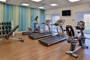 A gym with treadmills, dumbbells, and a TV on the wall. - Holiday Inn Express & Suites Southgate - Detroit Area by IHG (Southgate)