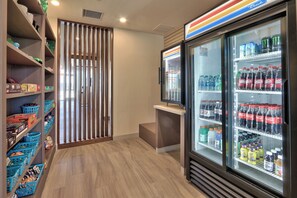 A vending area with various snacks and drinks, including Dr. Pepper and Coca-Cola. - Holiday Inn Express & Suites Roswell by IHG (Roswell)