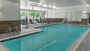 A swimming pool with clear water, surrounded by lounge chairs and a tiled deck. - Fairfield Inn & Suites by Marriott Atlanta Acworth (Acworth)