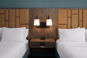 A hotel room with two beds, a nightstand with a lamp, and a control panel. - Hampton Inn & Suites Memphis Germantown (Germantown)
