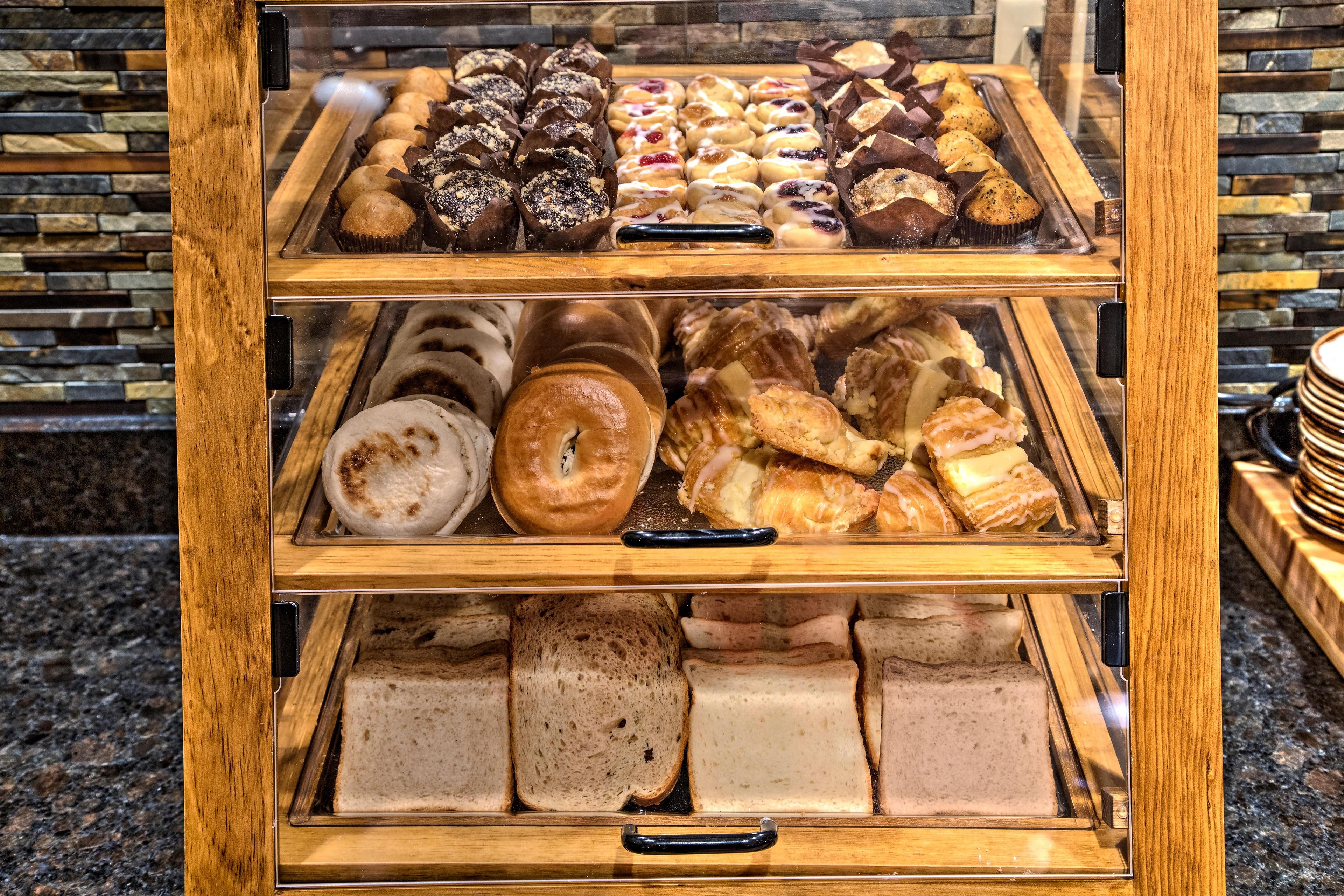A bakery display case with various baked goods.
