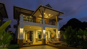 A two-story building with a balcony, outdoor seating, and a staircase. - The Best Aonang Villas (Krabi)