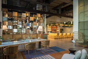 A modern bar area with wooden shelves, seating, and a bar counter.
