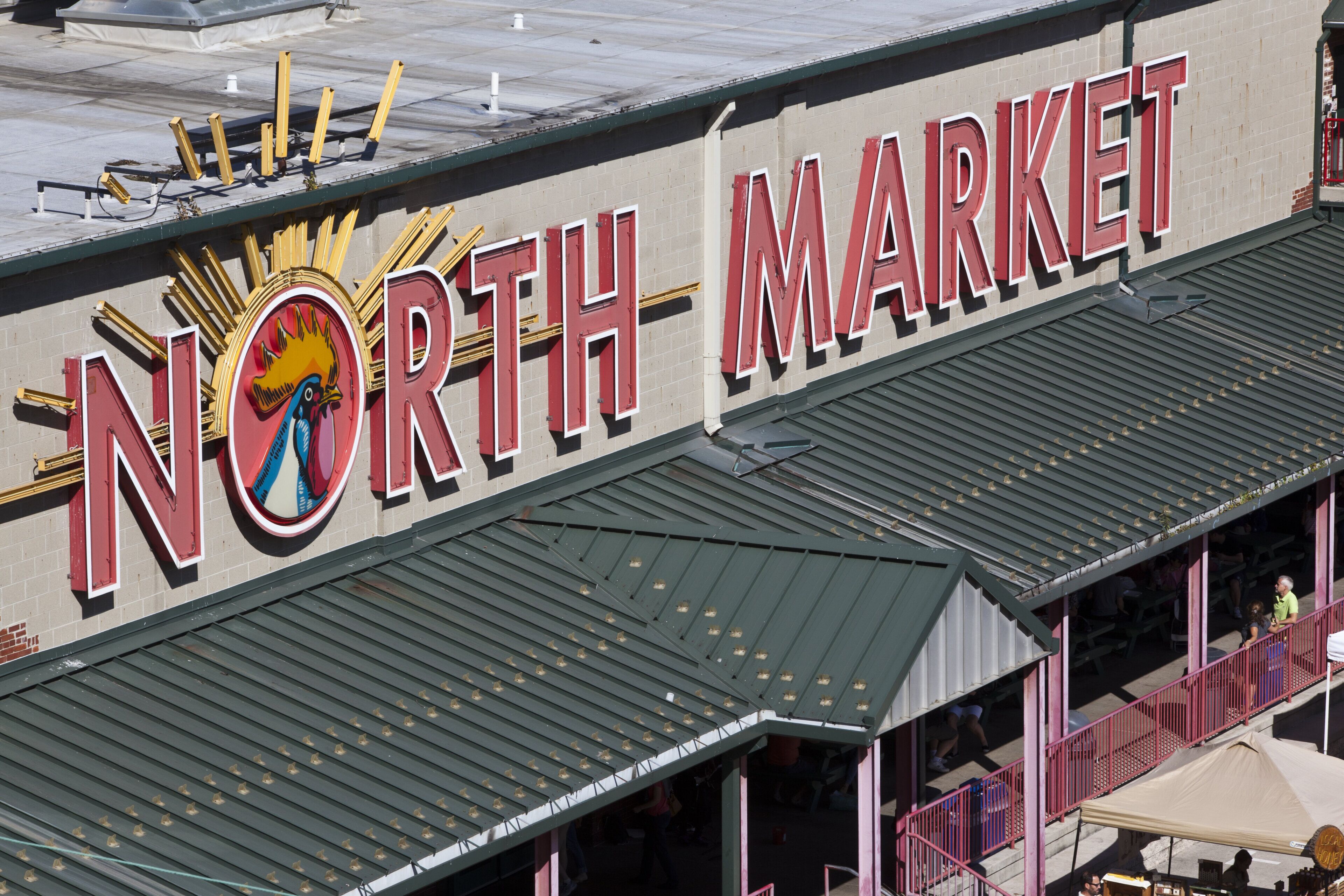 A building with a large sign reading 'NORTH MARKET' and a colorful rooster logo.