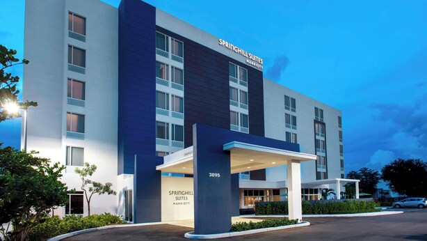 A modern hotel with a large entrance and a sign reading "Springhill Suites".