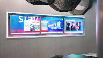 A hotel lobby with a large digital display advertising 'Springhill Suites' and 'Marriott'.