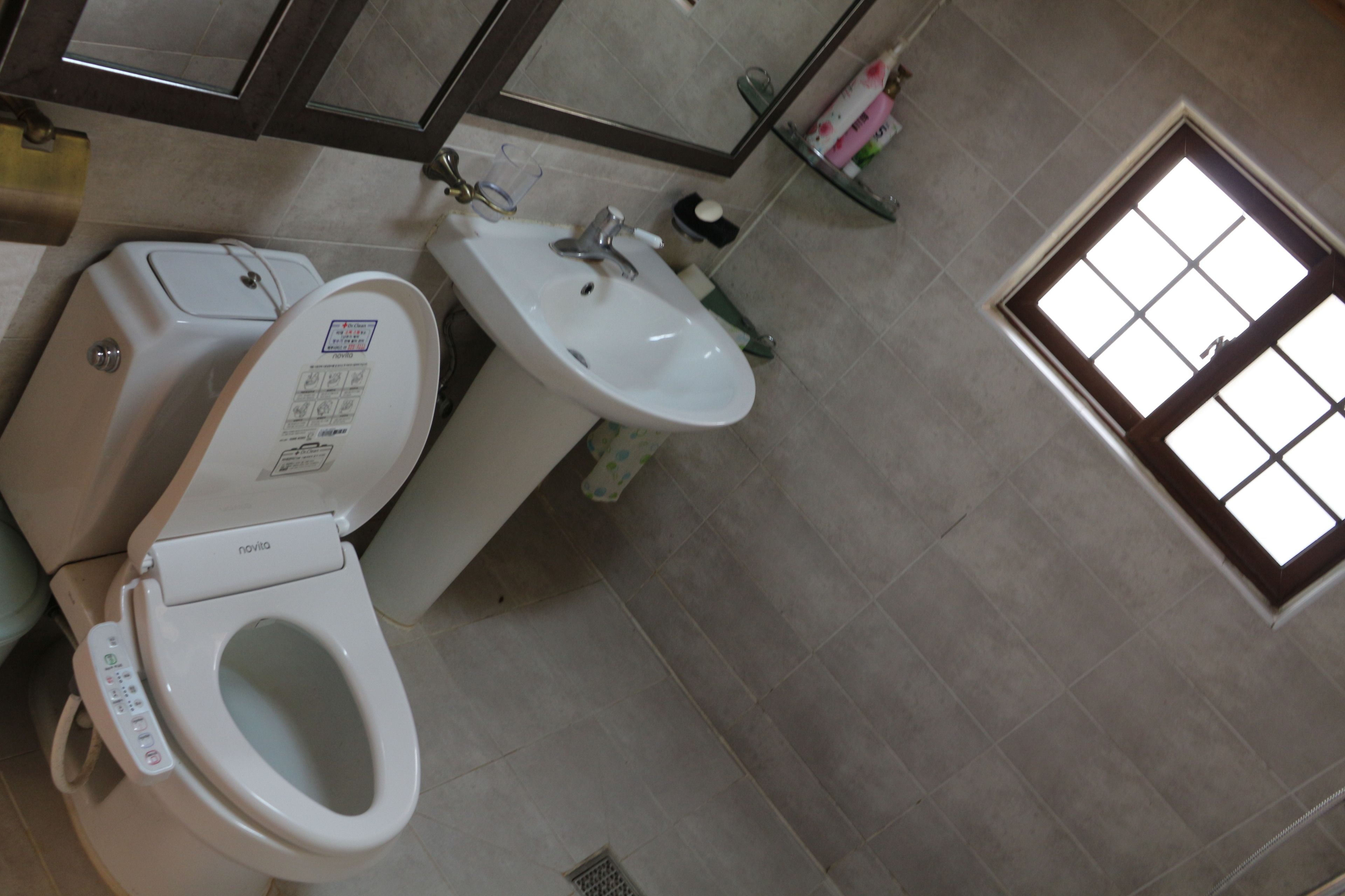 A bathroom with a toilet, bidet, and sink.