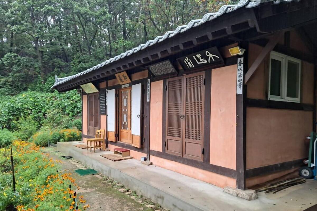 A traditional Japanese-style building with a tiled roof and wooden doors.