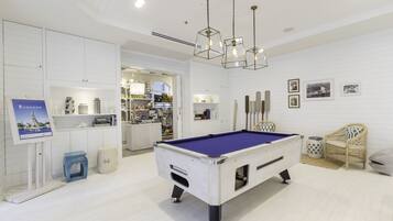 Relax and unwind in this inviting space, featuring a pool table and comfortable seating area.