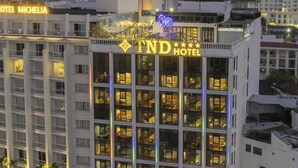 A multi-story hotel with a prominent sign reading "TND Hotel." - TND Hotel (Nha Trang)