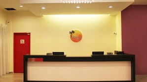 A reception desk with a sign that reads "Marge Hotel."