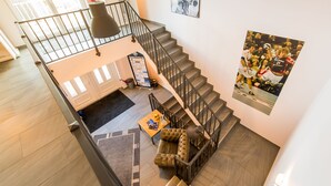 A spacious living area with a staircase, a sofa, and a coffee table.