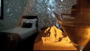 A room with a bed, a nightstand, and a martini glass on a table. The wall has a starry night sky design. The text 'NORTH GLACIER & OCEAN' is visible. - The Robin Hill Hotel (Torquay)