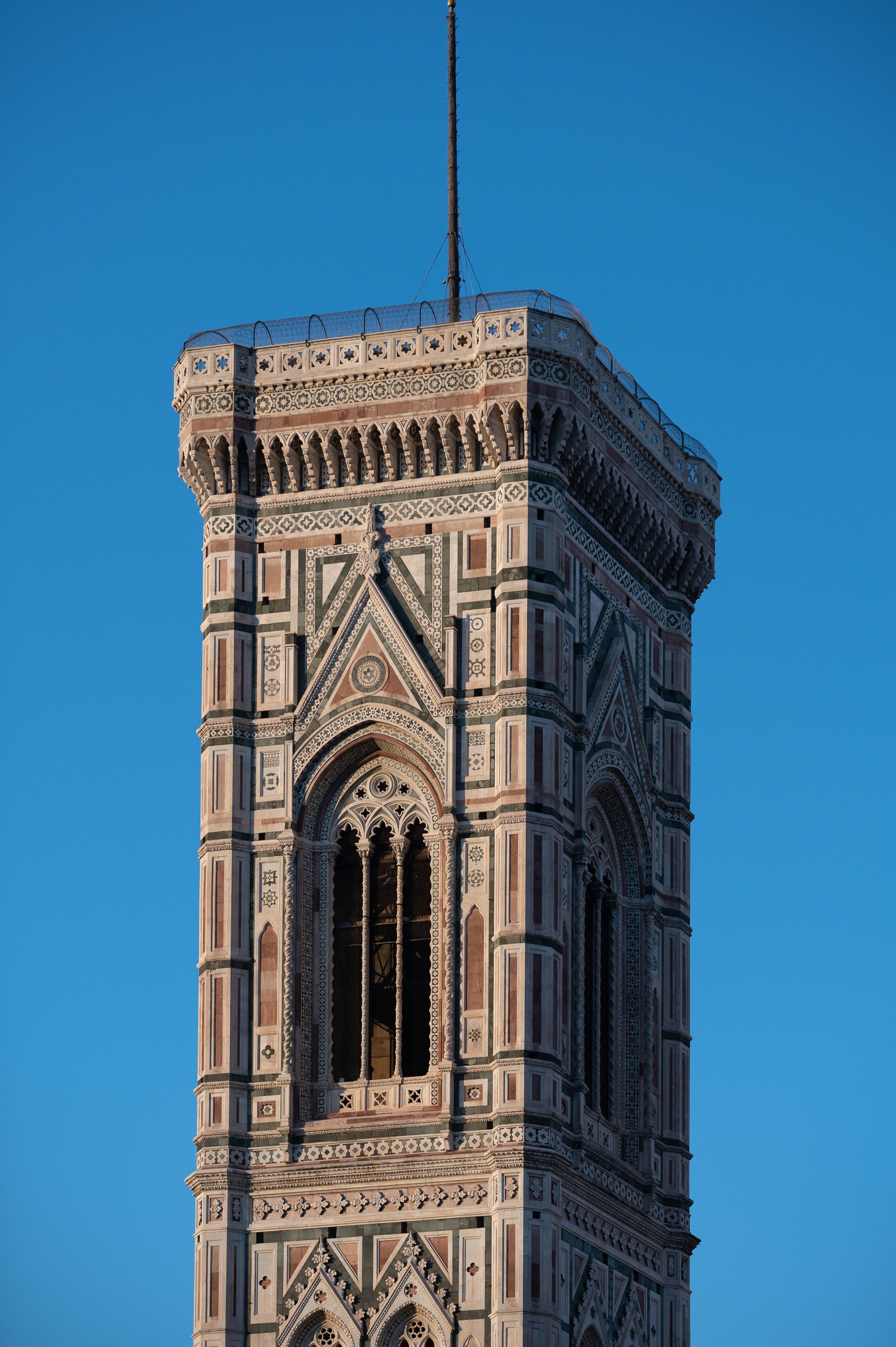 Una torre alta y ricamente decorada, con ventanas en arco y diseños ornamentales.