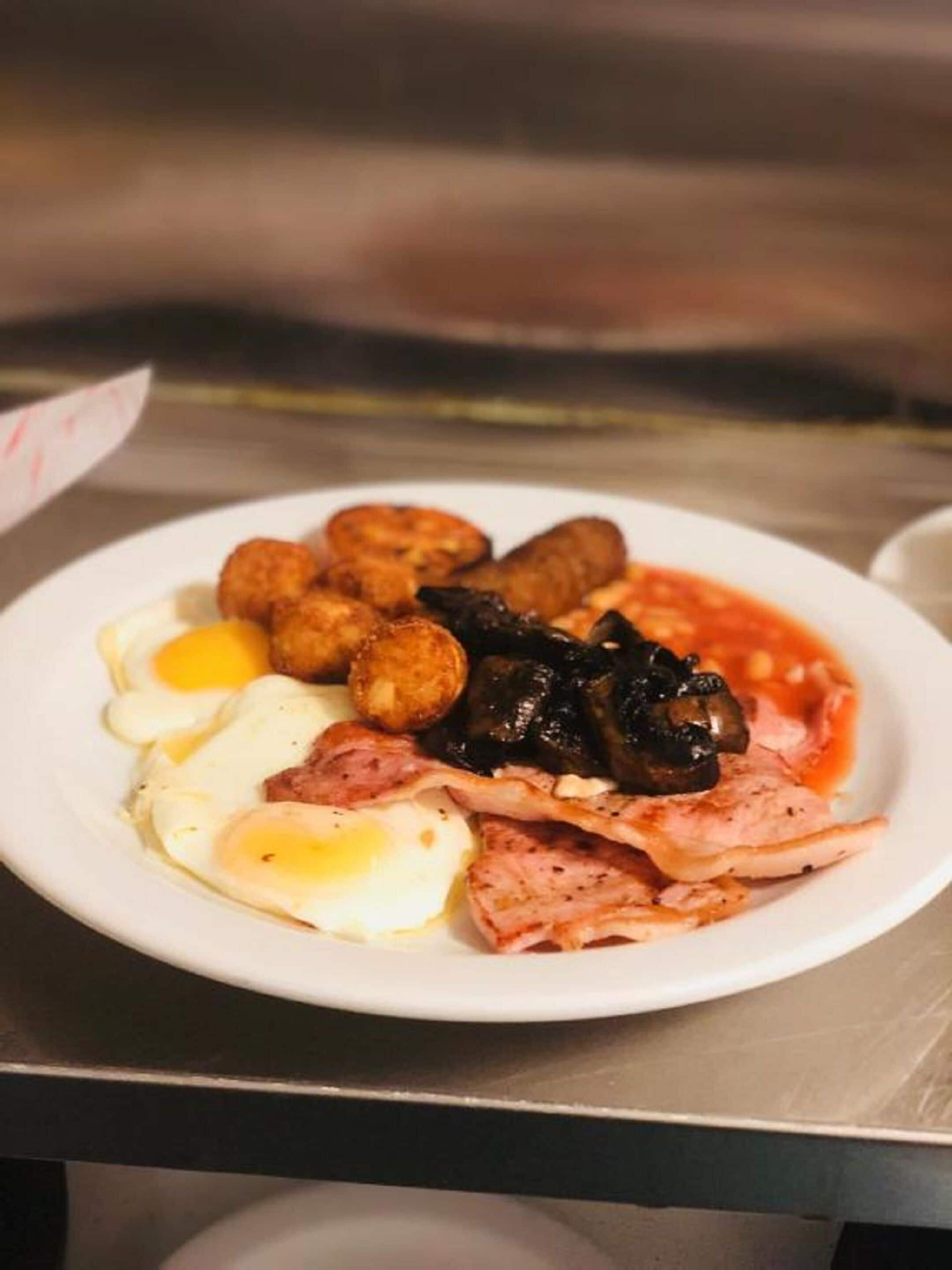 A plate of food including eggs, sausages, and mushrooms.