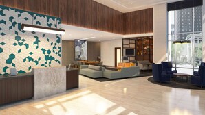 A modern lobby with a reception desk, seating area, and large windows offering views of the city. - Hyatt Place Austin Airport (Austin)