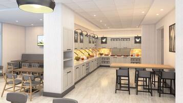 A modern restaurant with a central island, seating arrangements, and a television screen.
