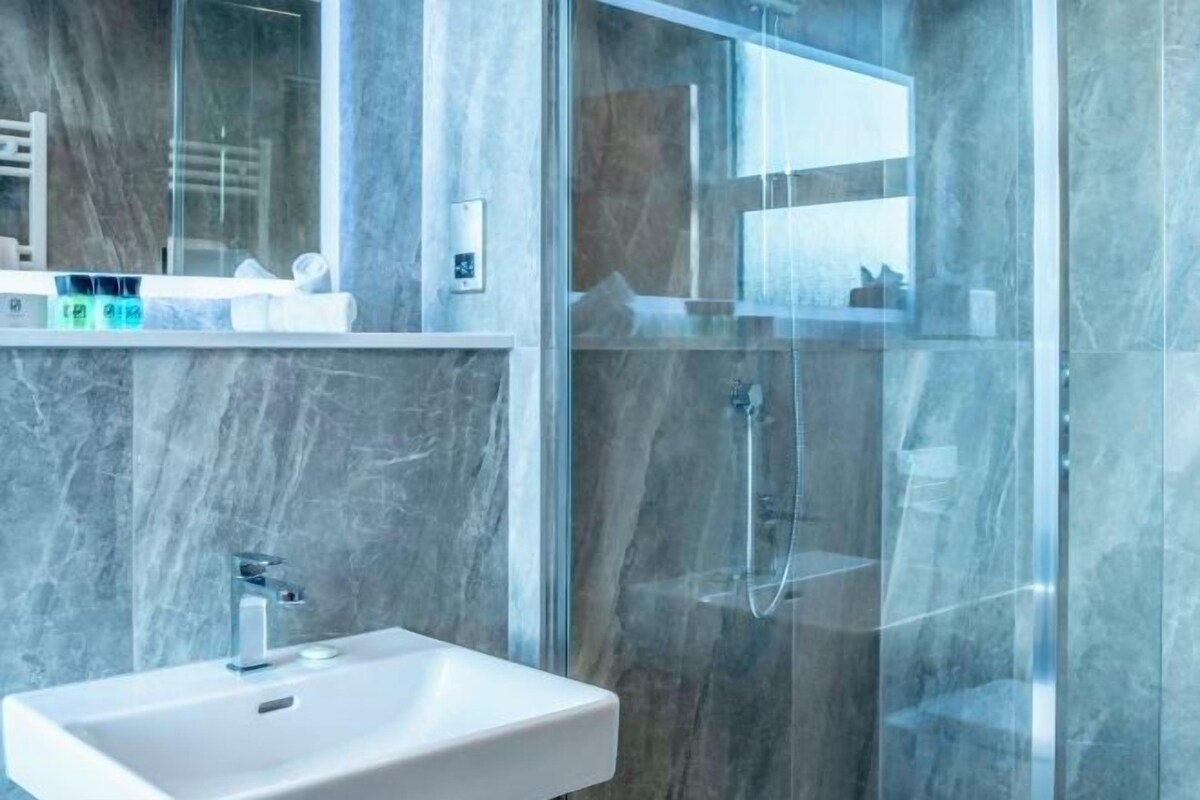 Bathroom | Shower, hair dryer, slippers, towels
