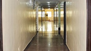 A long, narrow hallway with doors on both sides, leading to rooms. - Keviz Hotel (Lagos)