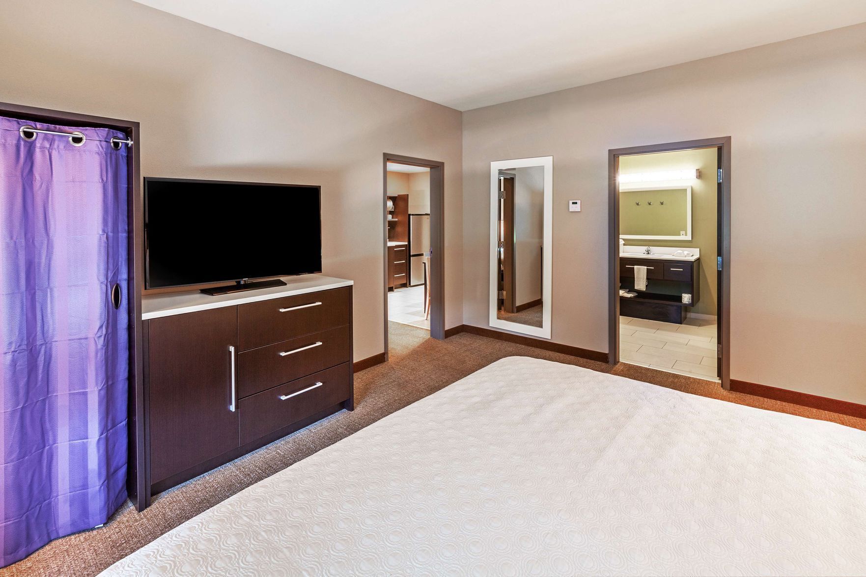 Hypo-allergenic bedding, desk, laptop workspace, blackout curtains