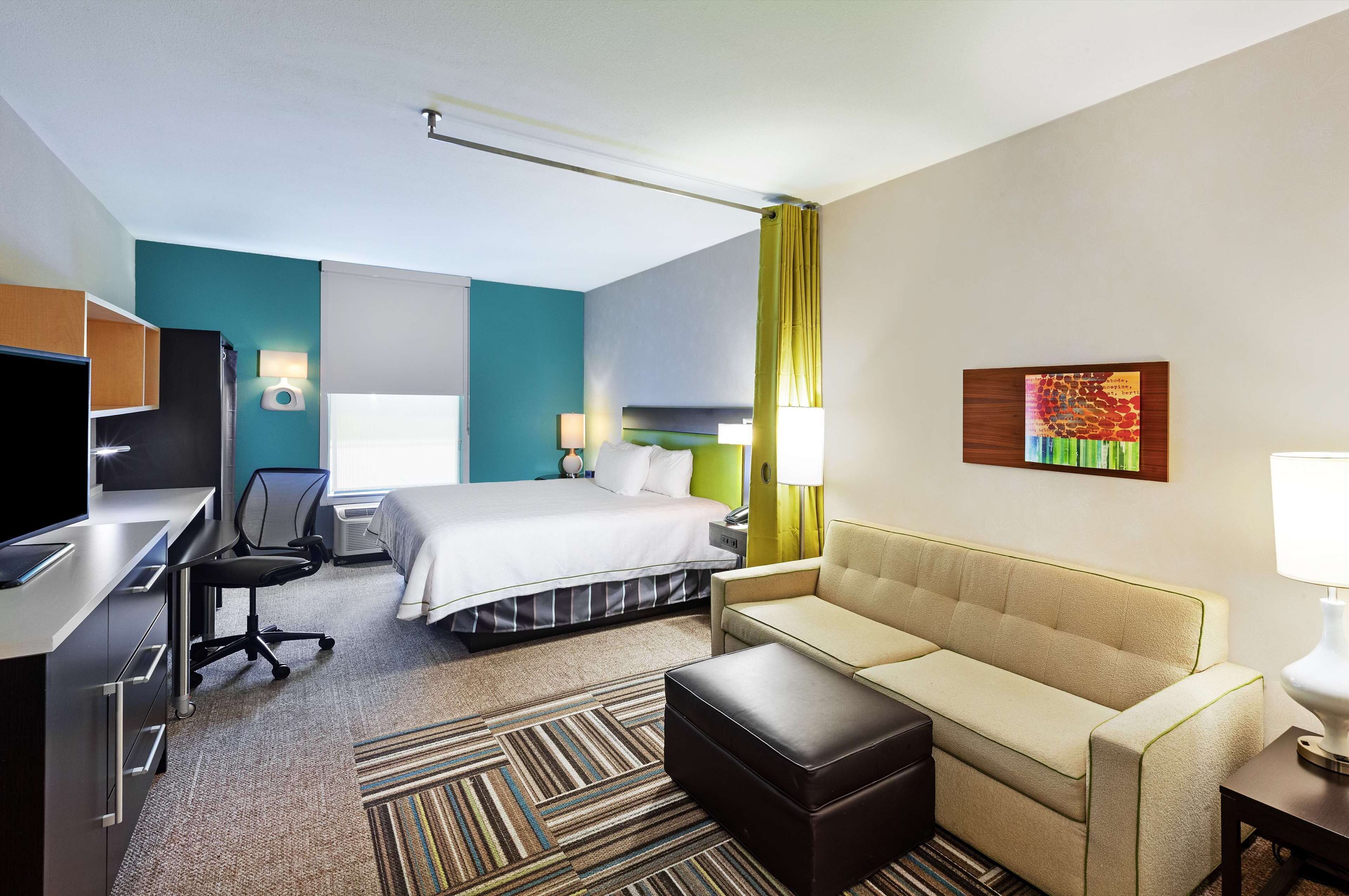 hypo-allergenic bedding, desk, laptop workspace, blackout curtains