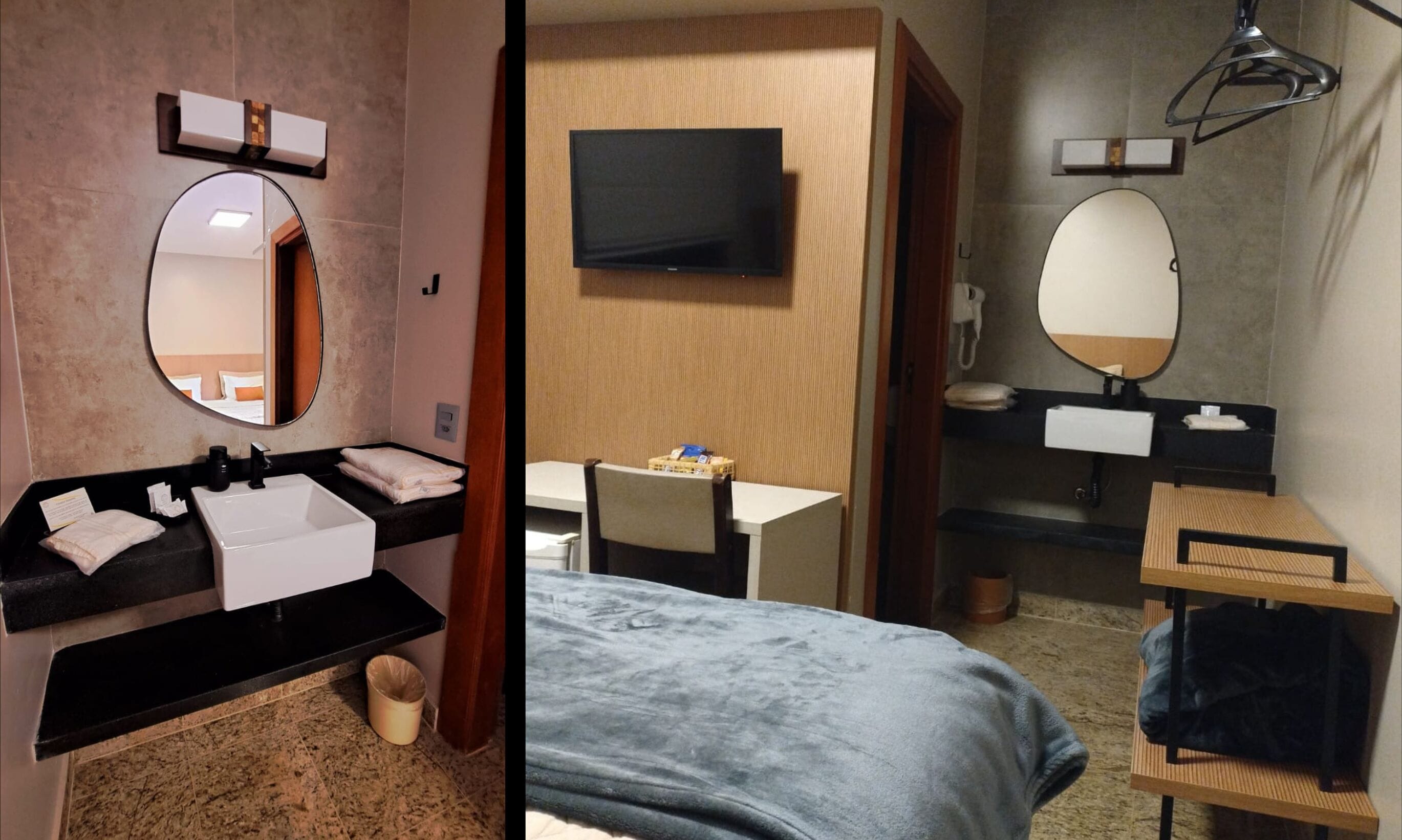 Habitación de hotel con un espejo redondo, un televisor de pantalla plana, un escritorio y una cama con manta azul.
