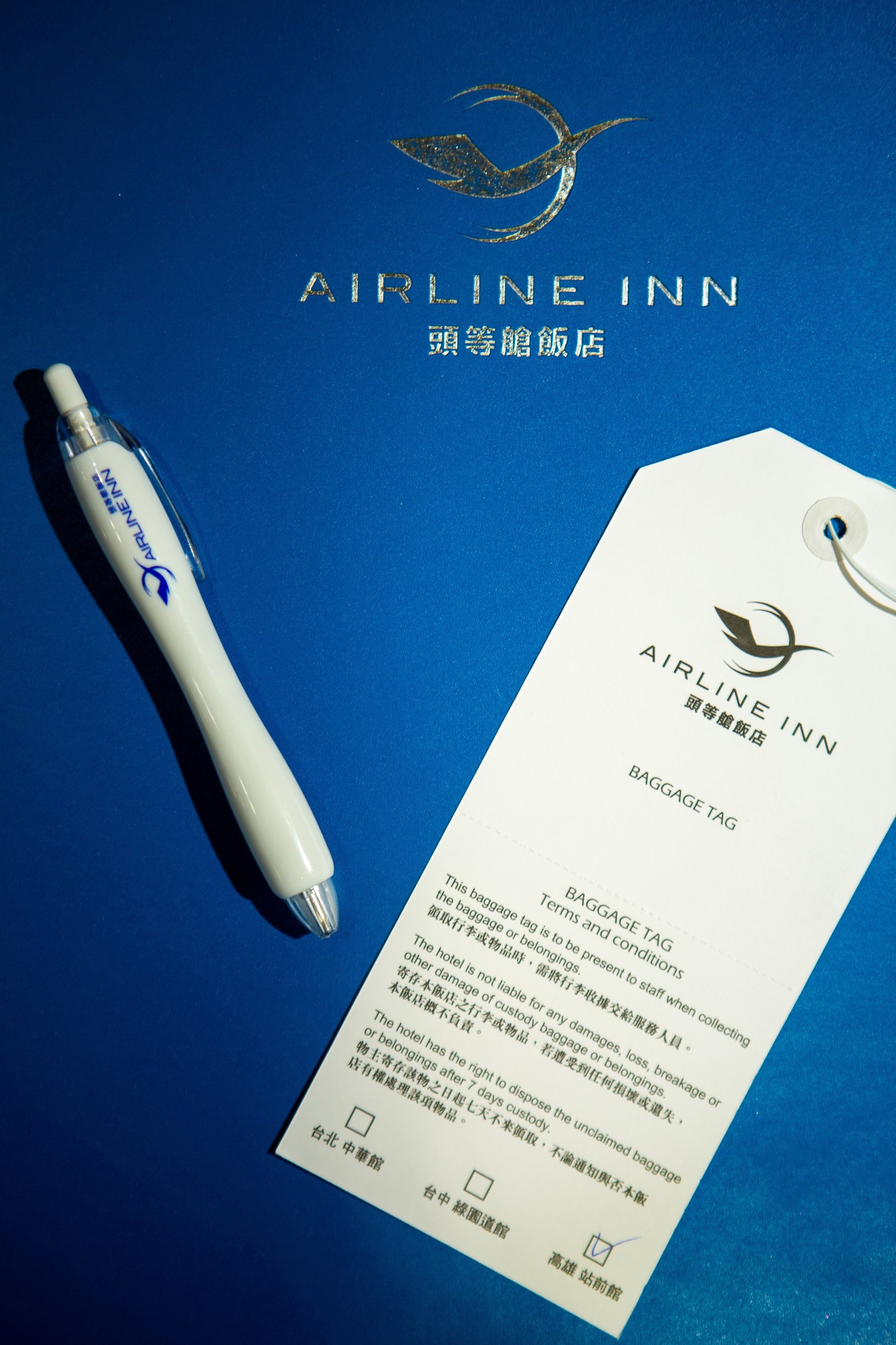 A baggage tag from Airline Inn with a pen beside it.