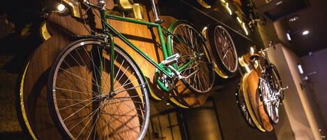 A bicycle mounted on a wooden wall with other bicycles.