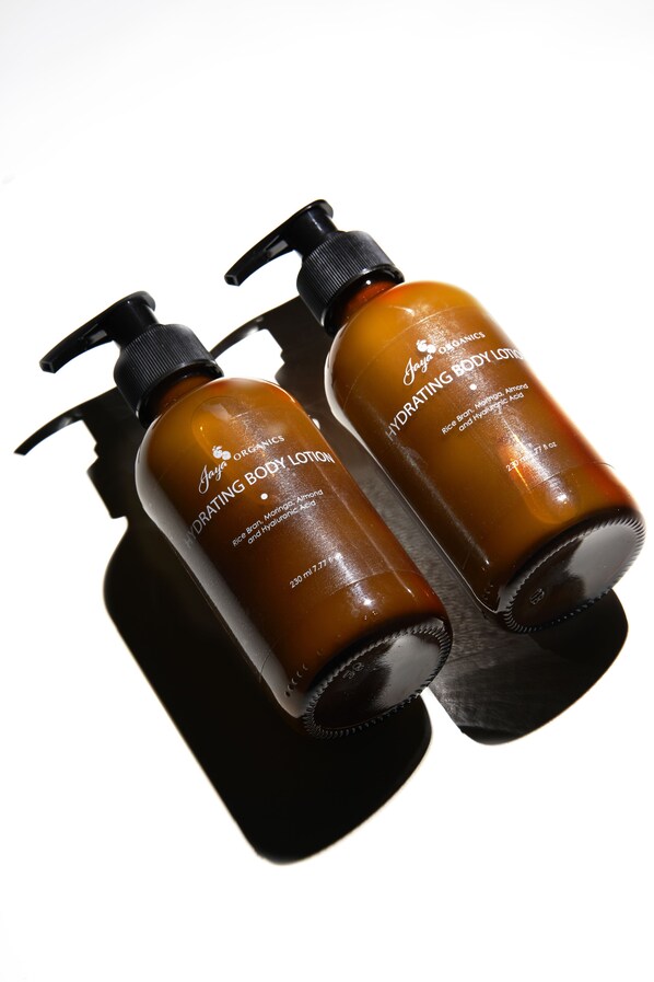 Two bottles of Jayo Organics Hydrating Body Lotion against a white background.