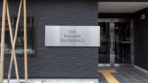A modern building entrance with a sign reading "THE PAGODA EXPERIENCE". - The Pagoda Experience (Kyoto)
