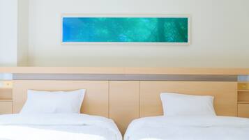 A hotel room with two beds, a wooden headboard, and a framed picture on the wall.