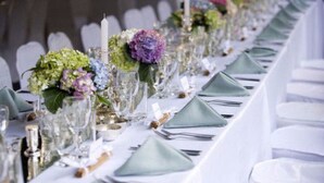 A long table set for a formal event with glassware, napkins, and floral centerpieces. - The Dutch House (Galle)