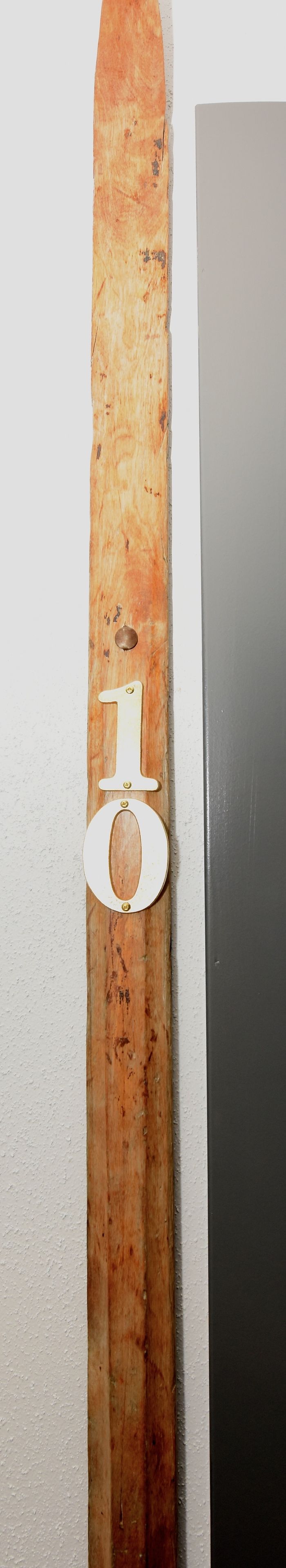 A wooden door with a number '1' and a circular cutout.