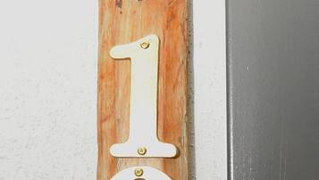A wooden door with a number '1' and a circular cutout.