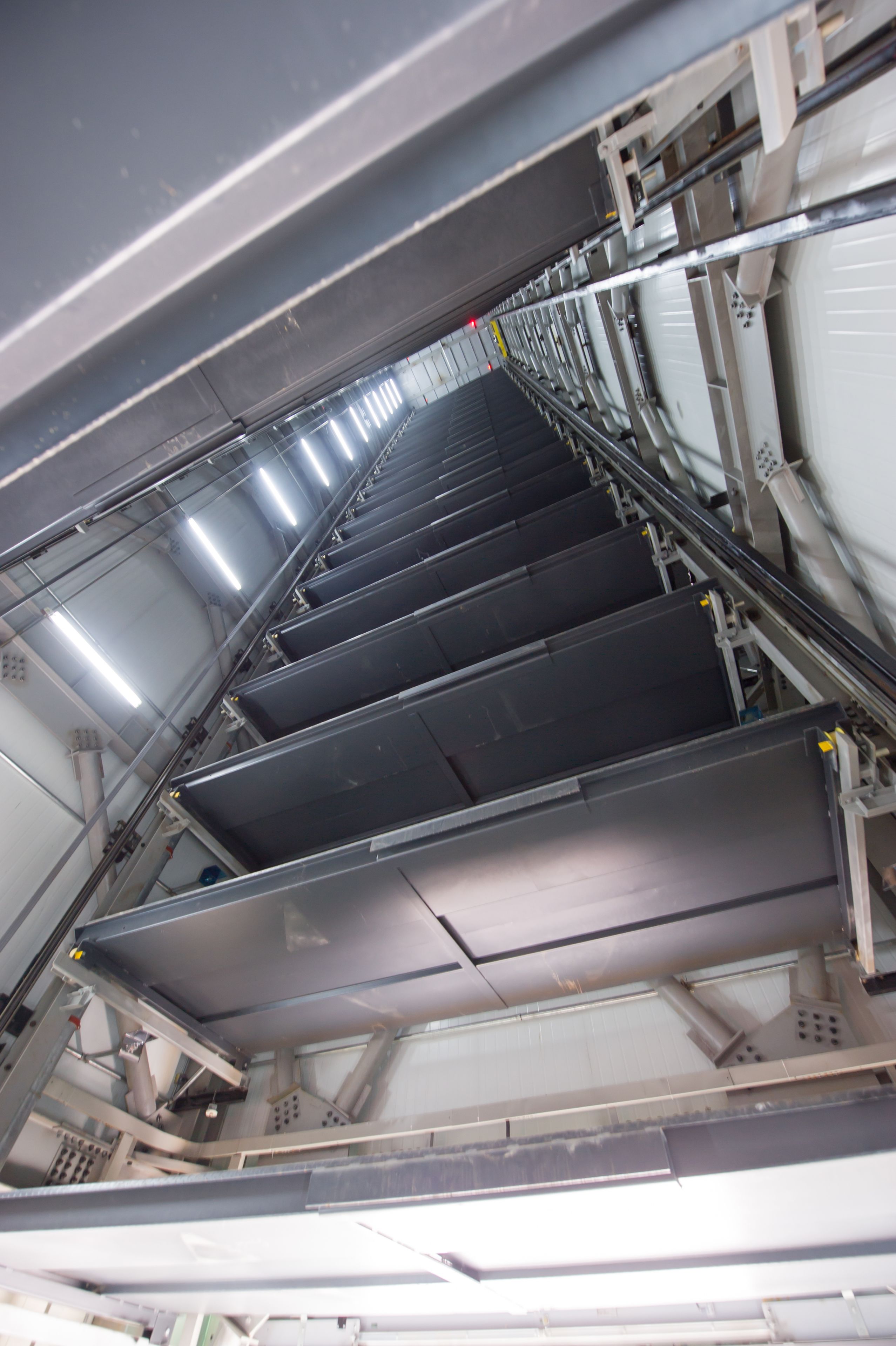 A series of empty, metallic, and industrial-style staircases with metal railings and no visible windows or doors.