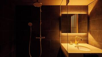 A modern bathroom with a shower, a sink, and a mirror.