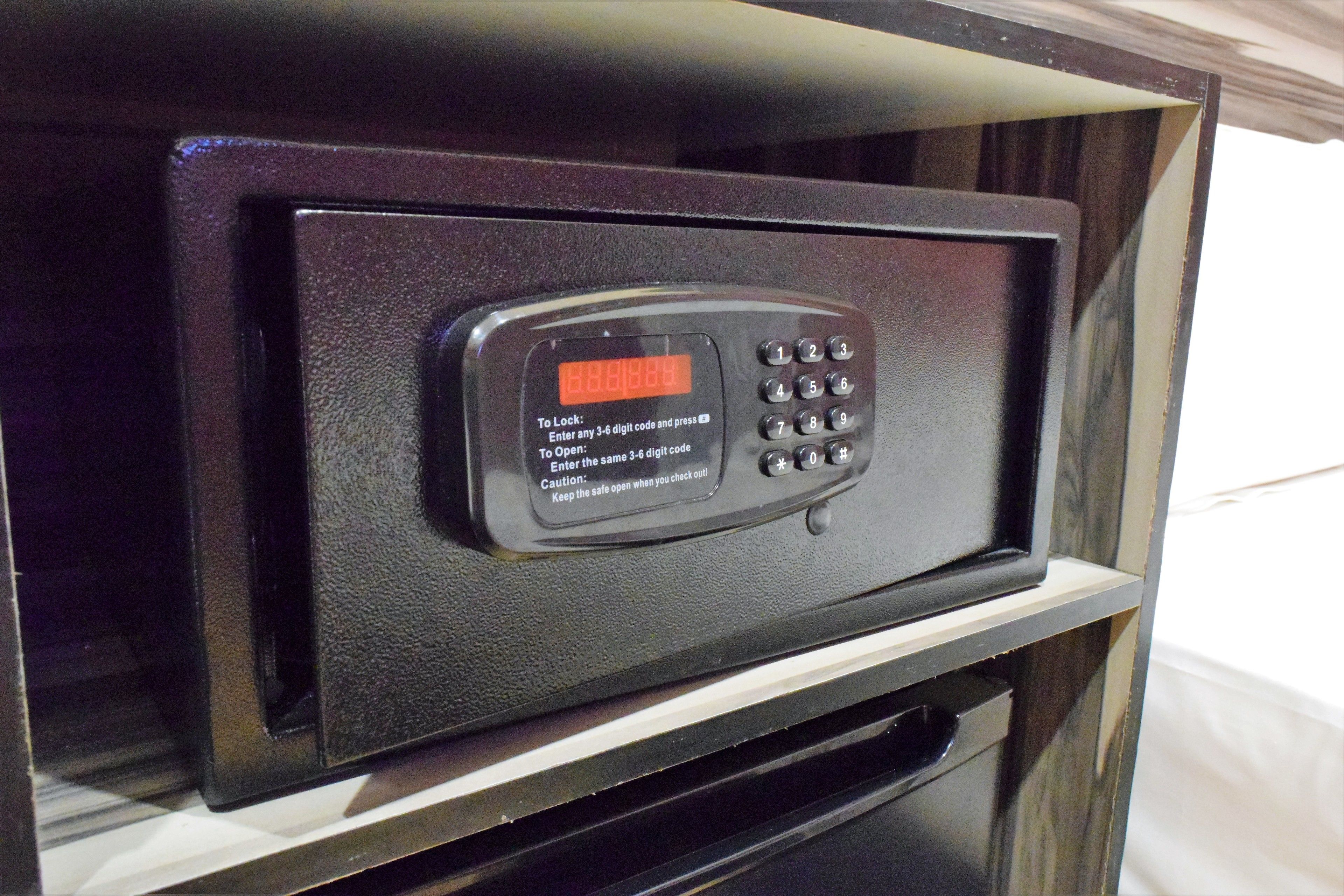A black electronic keypad with a digital display, likely for a hotel room's safe or control panel.