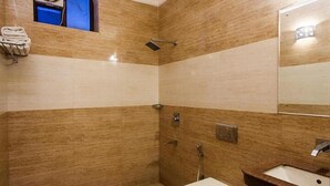 A bathroom with a shower, toilet, and sink. - Hotel Shubham Majesty (Mathura)