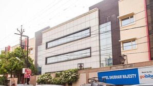 A modern hotel facade with large windows and a sign for 'Hotel Shubham Majesty'. - Hotel Shubham Majesty (Mathura)