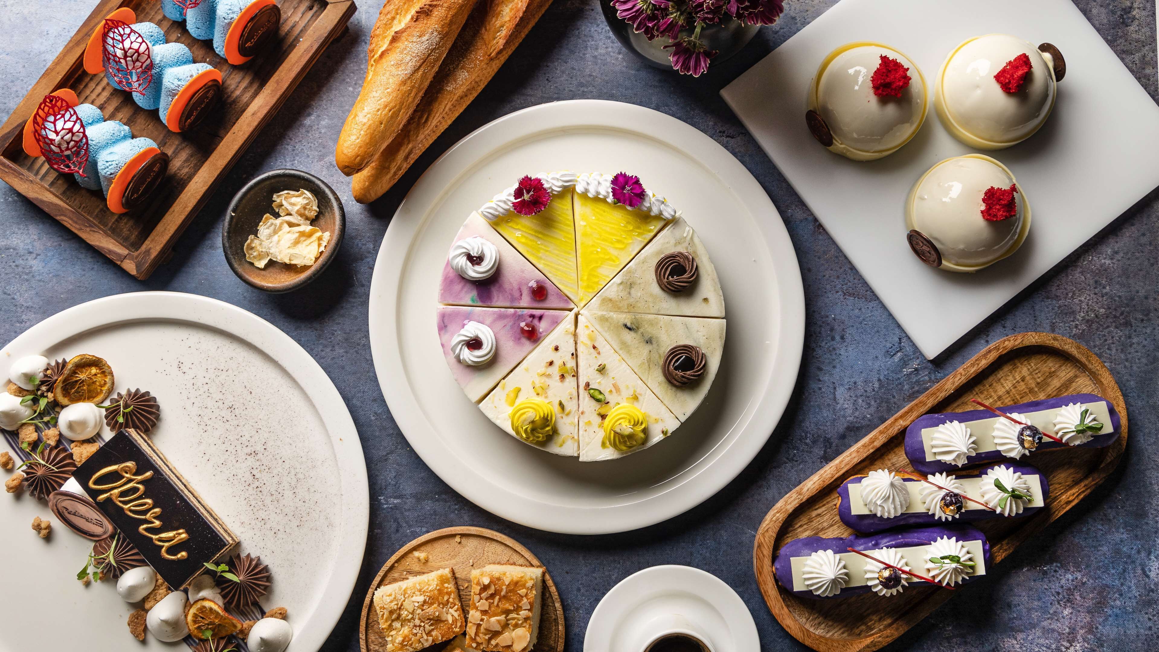 A variety of desserts and pastries on plates and trays.