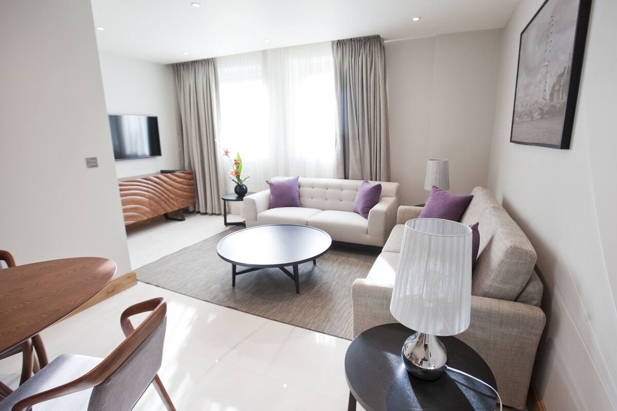 Deluxe Apartment, 1 Bedroom, Accessible | Living area | 50-inch flat-screen TV with digital channels, TV