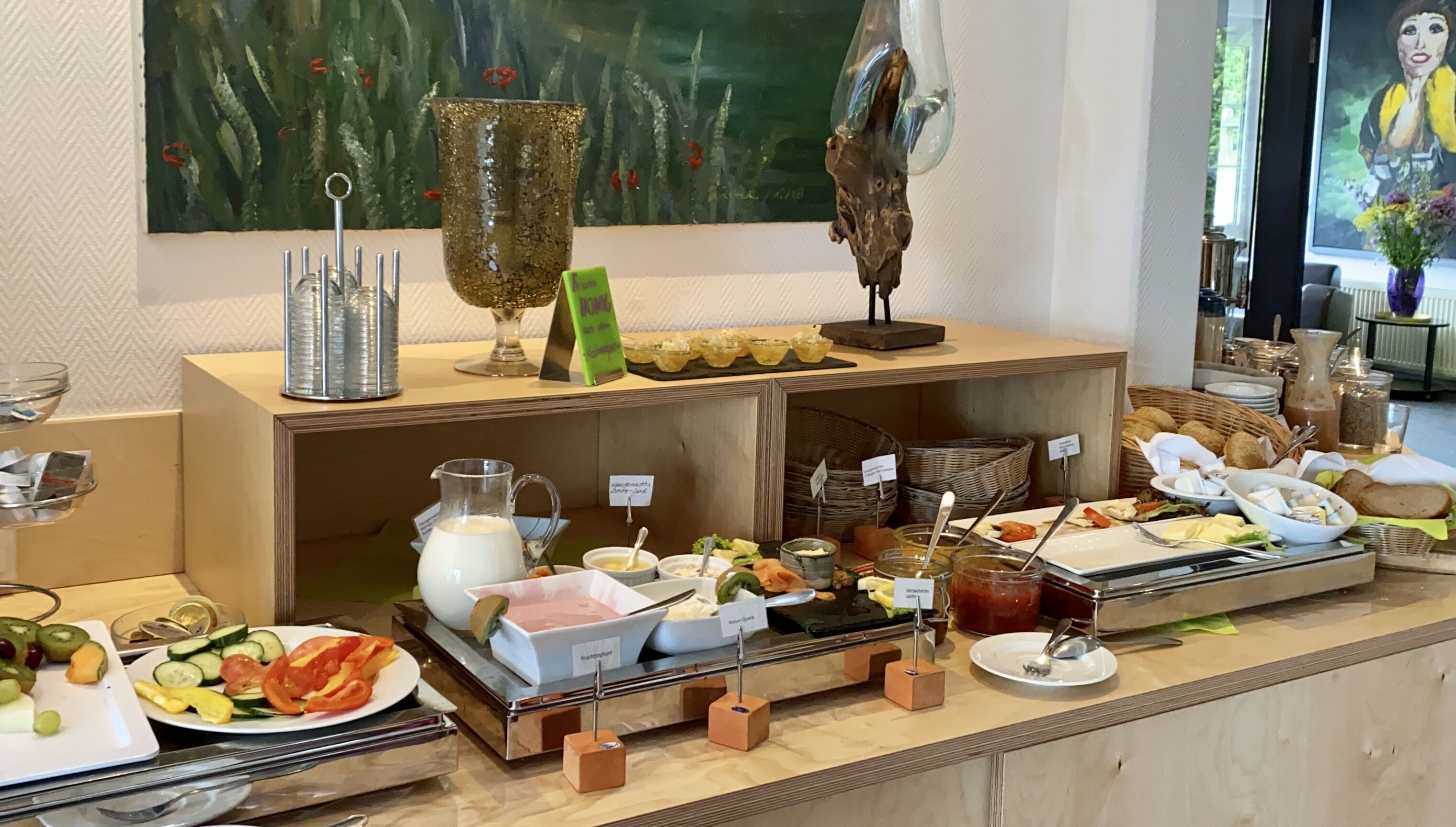 A buffet setup with various food items and beverages, including fruits, vegetables, and dairy products.